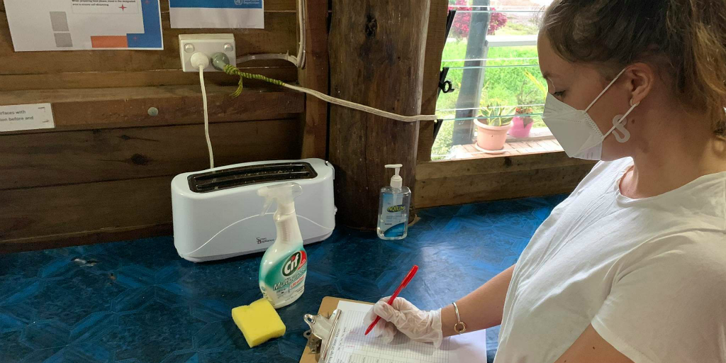 A volunteer taking the necessary Covid-19 cleaning precautions 