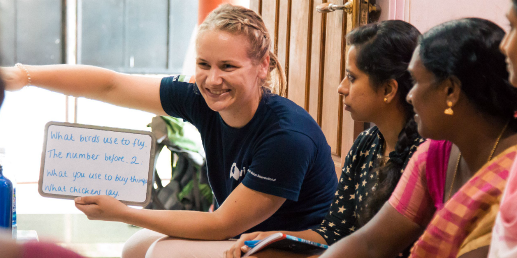 a volunteer in india teaching english on a womens empowerment program 