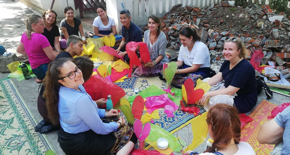 Participants in Laos crafting with locals