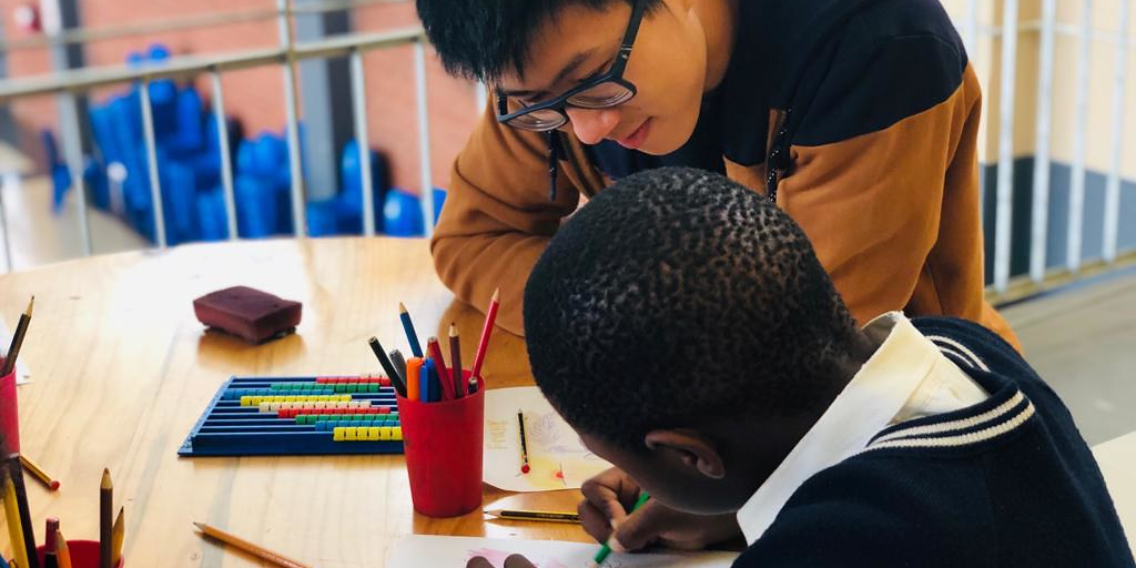 Participant helping child with studies