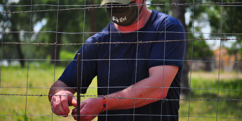 A GVI volunteer in limpopo doing fence repairs