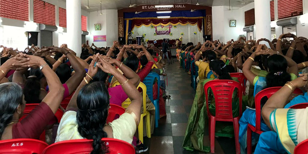 Women in India attend a talk.