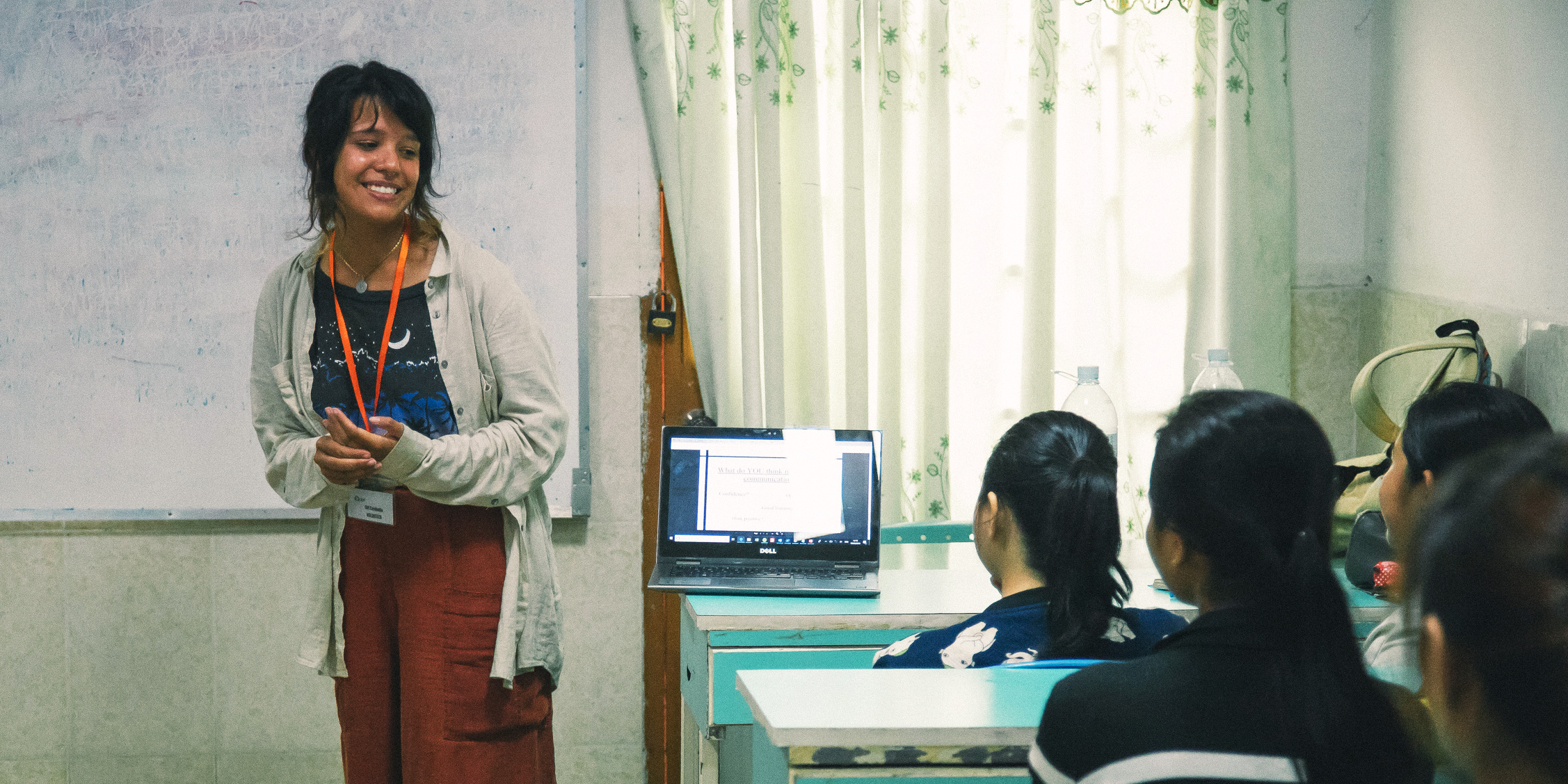 A woman leads an English lesson while on a gap year program.