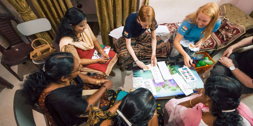 A group of women work on their English language skills as part of a women's empowerment program.