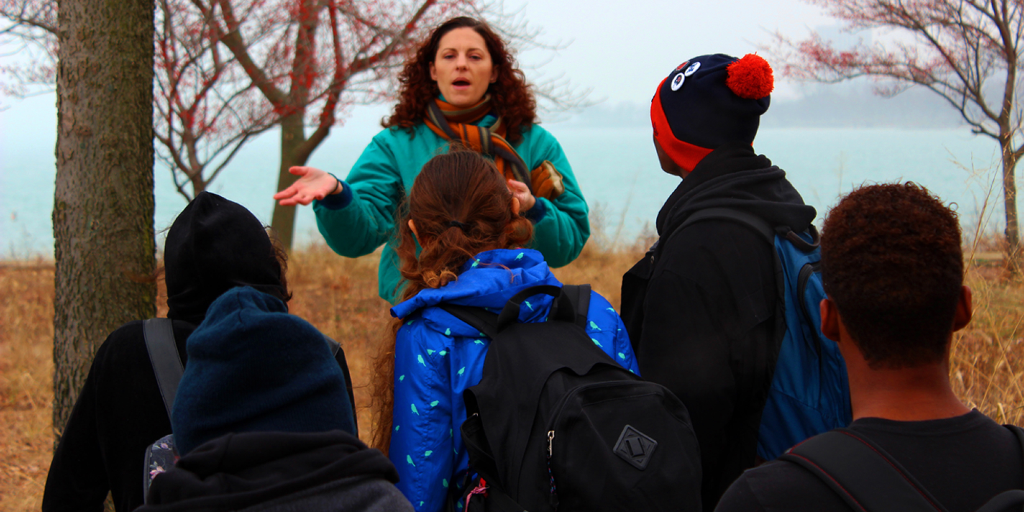 A lady speaks to the youth about an environmental restoration project. 