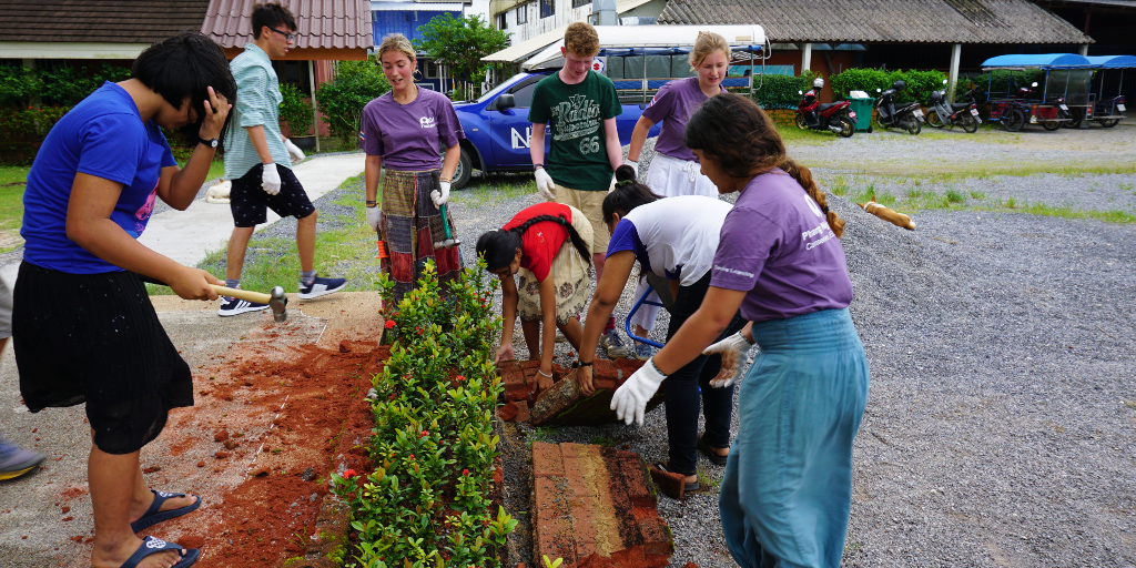 The GVI volunteers participate in an ecosystem restoration project by planting trees. 