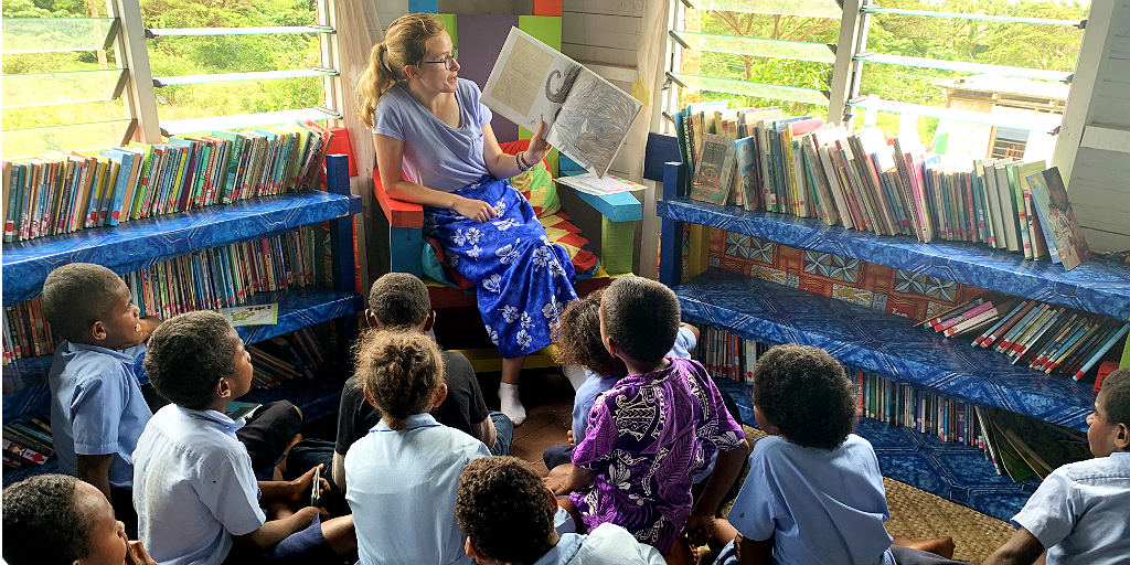 A woman reads a story to the children while being part of a language immersion program. 