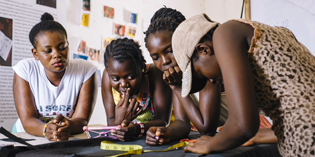 Ghanaian women are working on a sewing project in order to improve their sewing skills. 