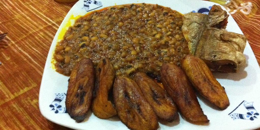 A plate of red red stew and fried plantain. 