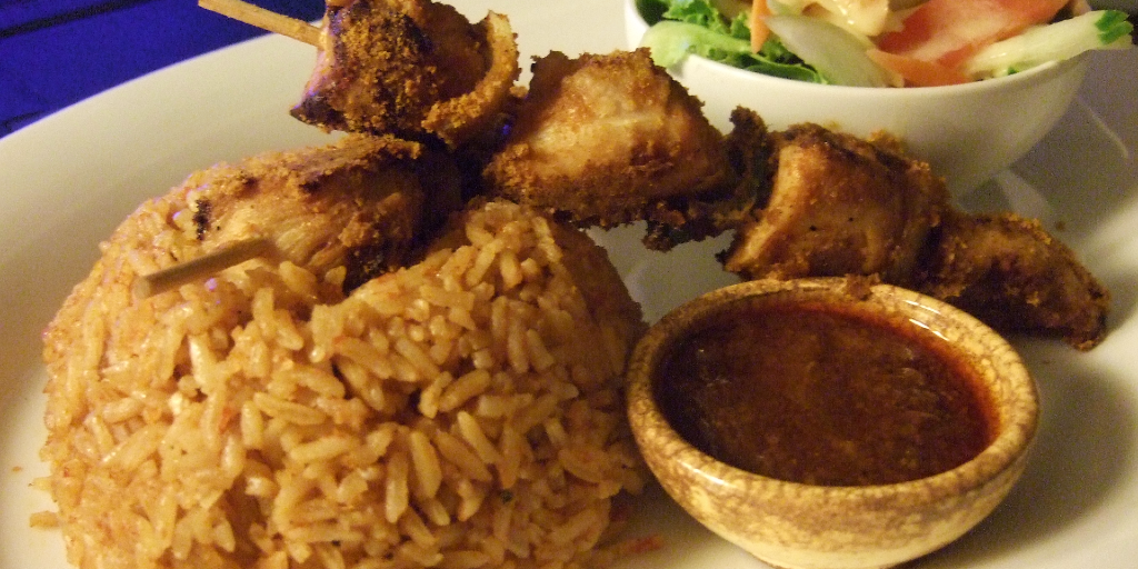 Ghanaian jollof rice with chicken kebabs. 