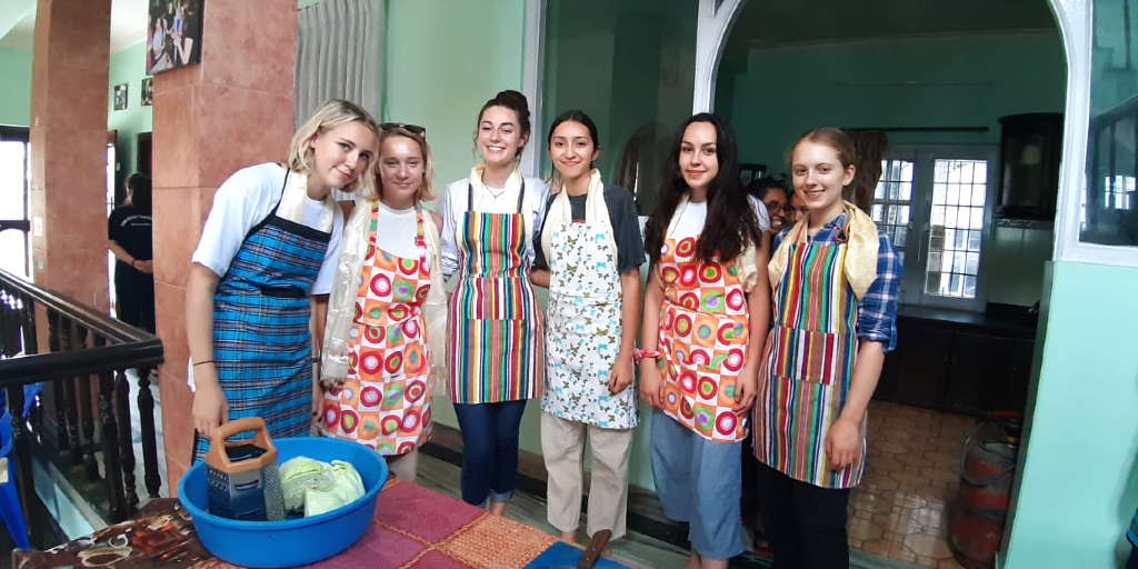 GVI 15 year old participants practice cooking local cuisine. 