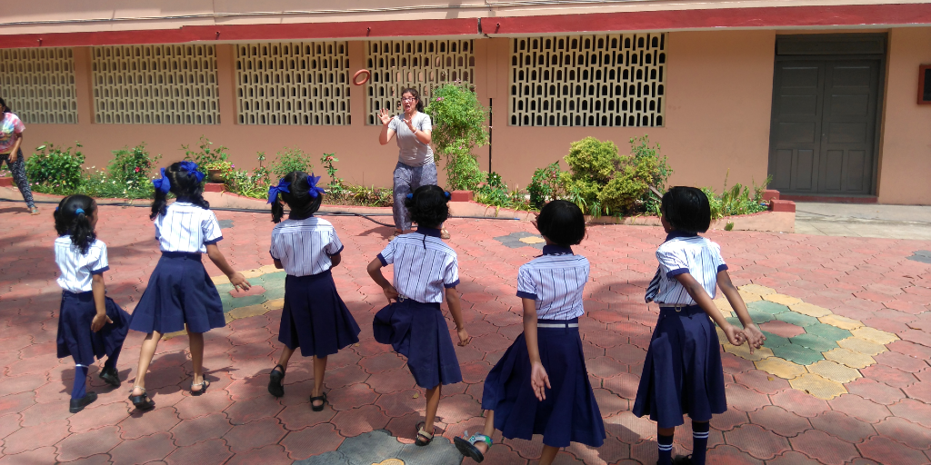 A GVI participant plays with the young girls at school. 