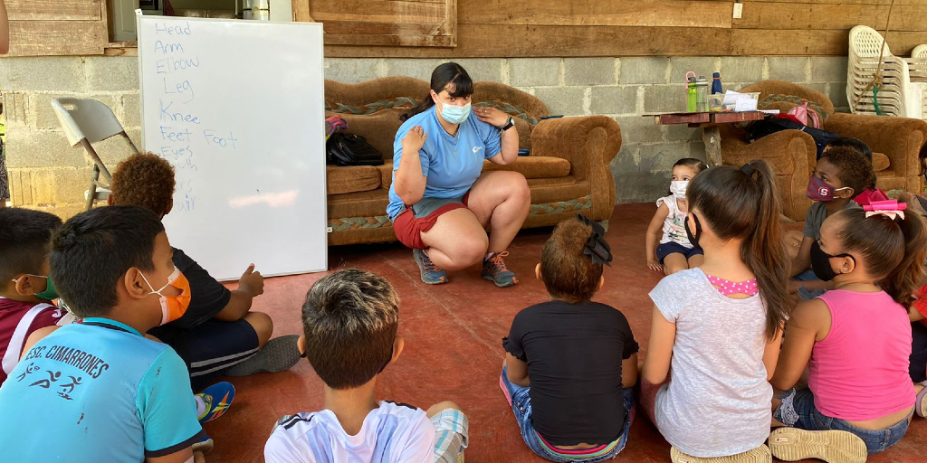 A gap year volunteer teaches the children about the body parts in Costa Rica.