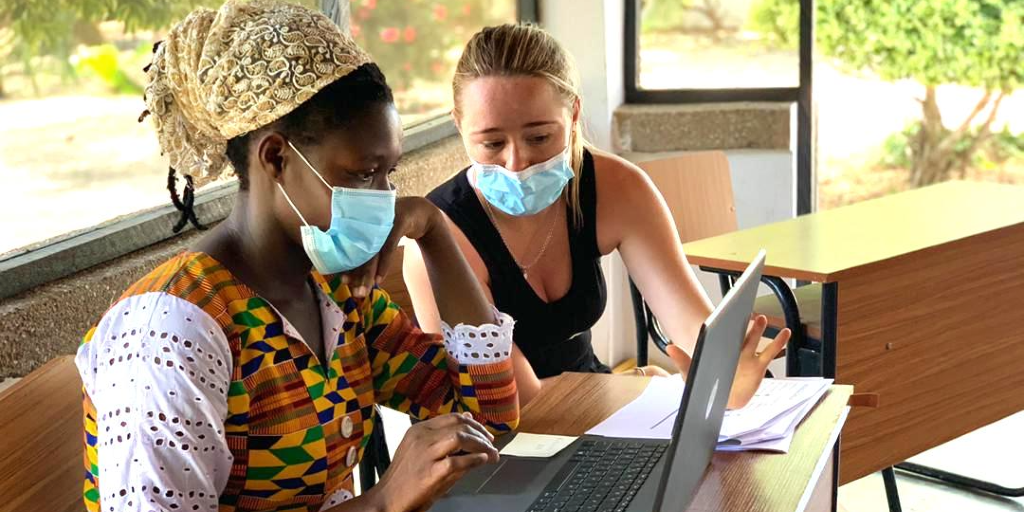 A GVI volunteer helps a lady improve her computer skills. 